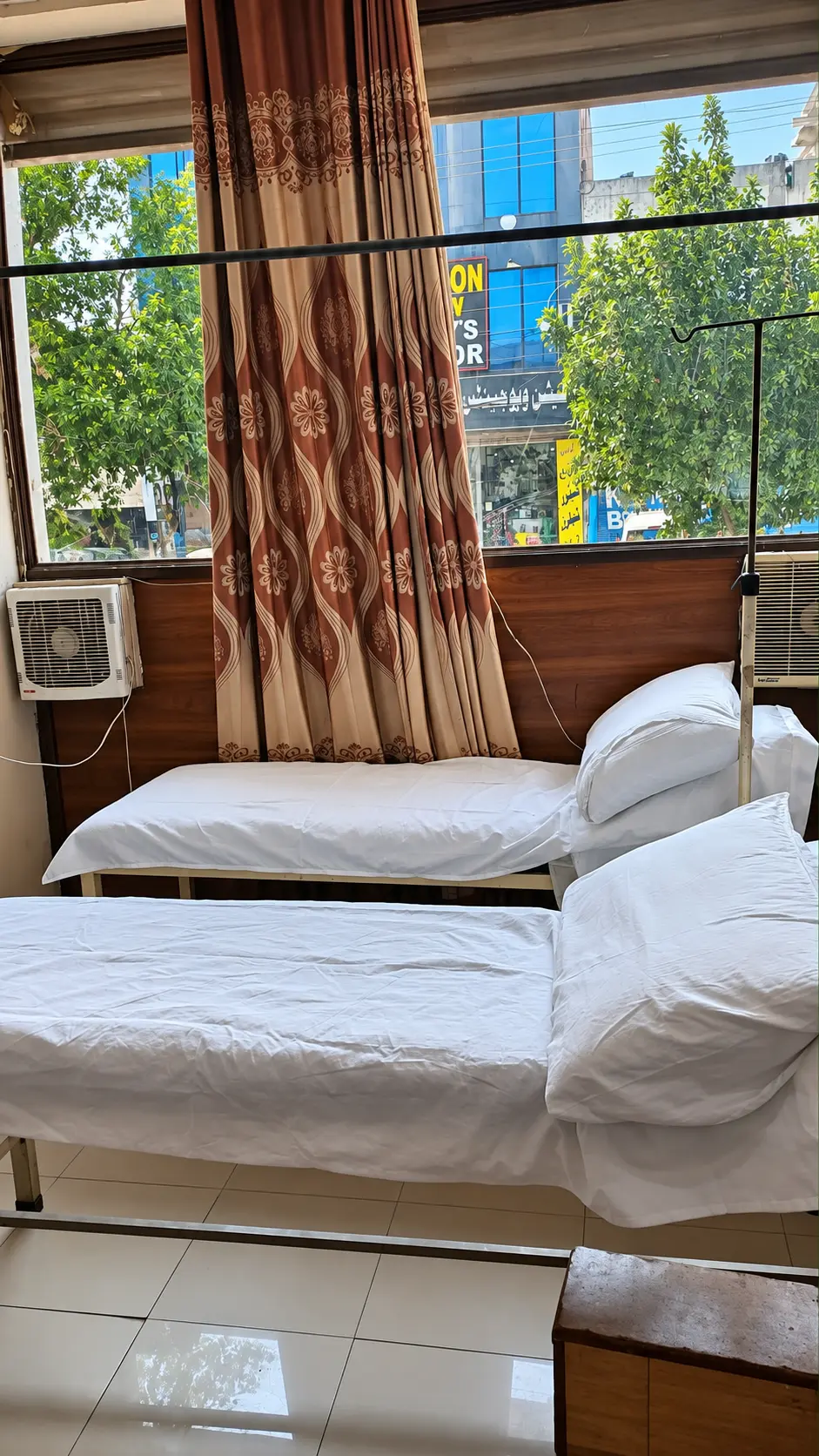 Two made-up patient beds in the treatment room at Minhas Clinic
